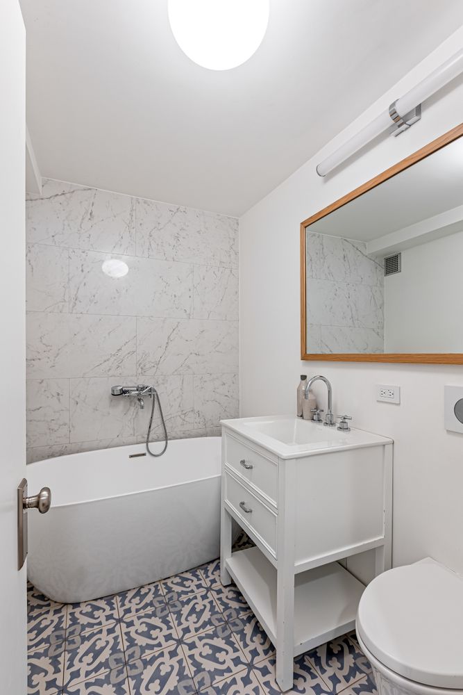 a bathroom with a sink a toilet and bathtub