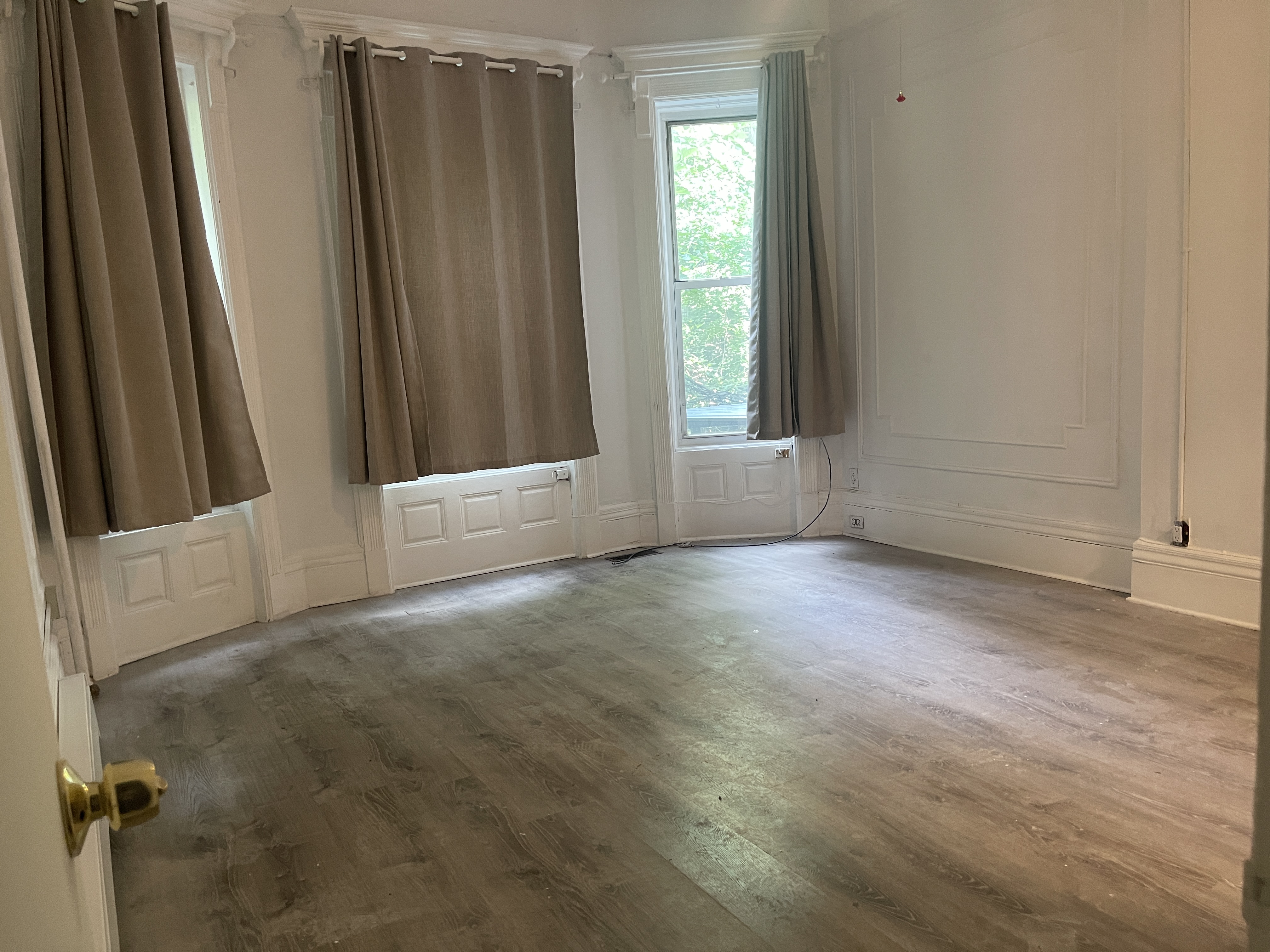 611 West 145th Street Manhattan, NY 10031 - Photo 2 of 8 an empty room with windows