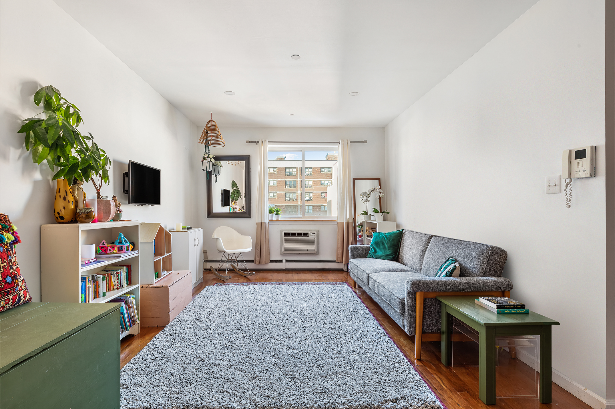 97 Moore Street, Unit 4B Brooklyn, NY 11206 - Photo 2 of 8 a living room with furniture and a flat screen tv
