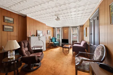a living room with furniture a window and a chandelier