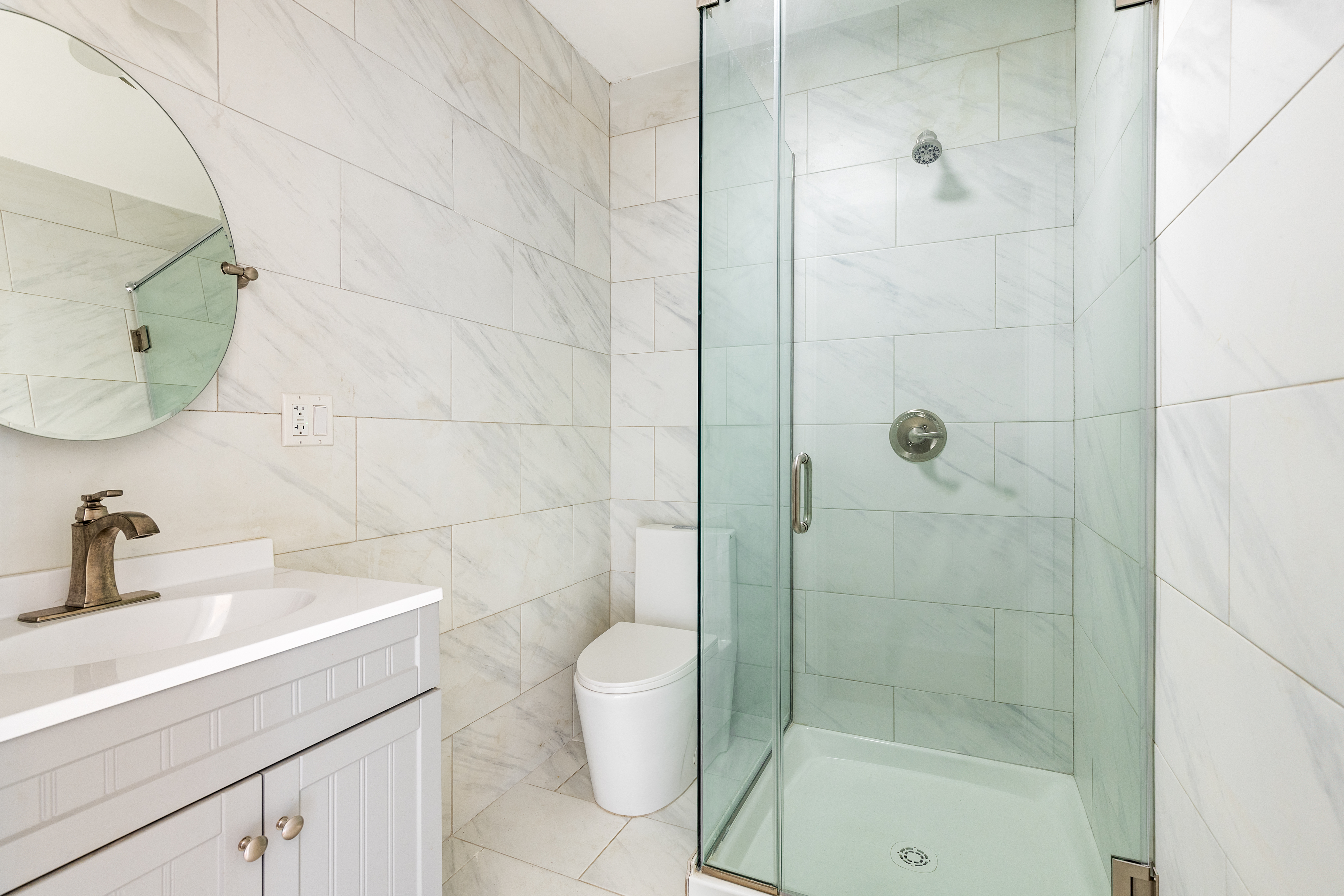 185 Bainbridge Street Brooklyn, NY 11233 - Photo 18 of 23 a bathroom with a sink a toilet and shower