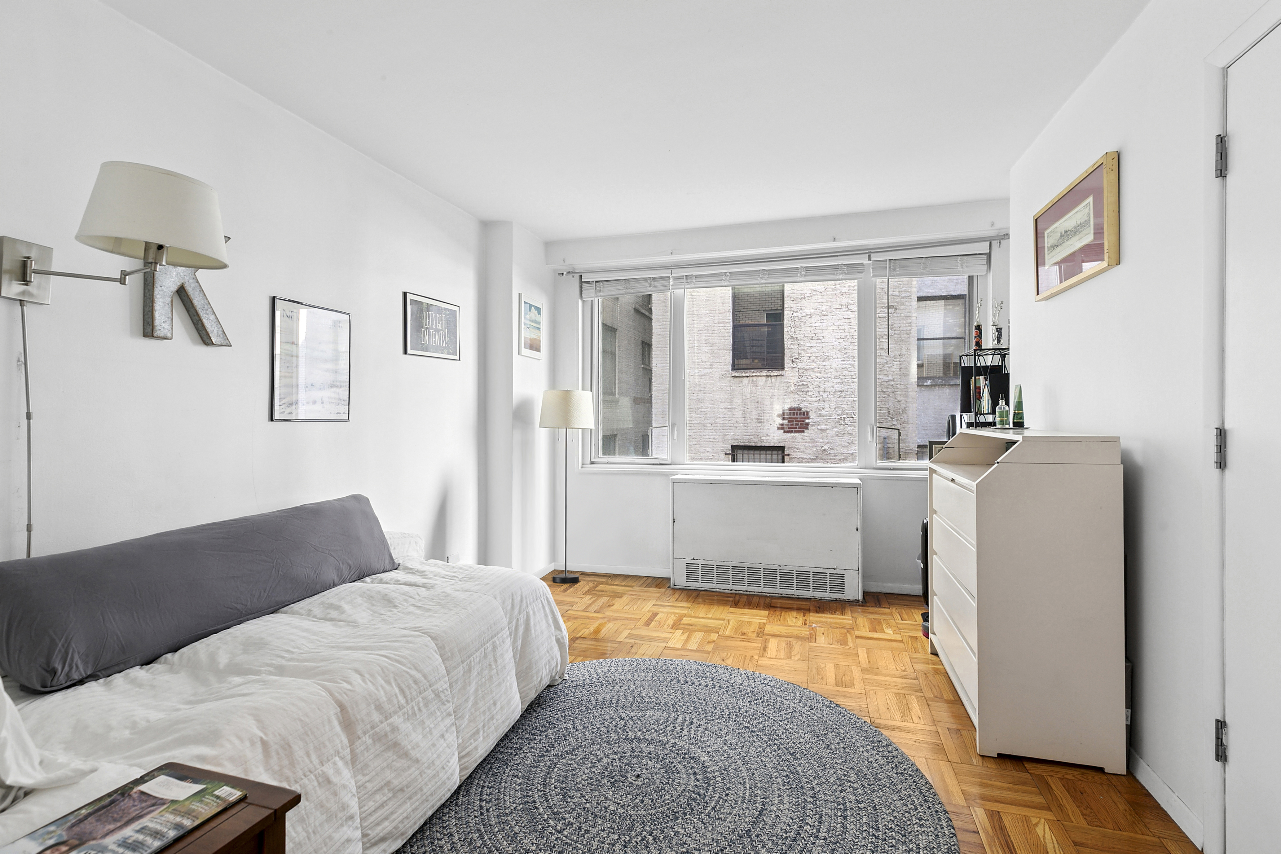 301 East 22nd Street, Unit 3PR Manhattan, NY 10010 - Photo 7 of 11 a living room with a bed furniture and next to a window