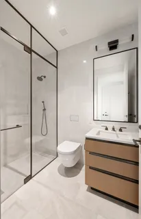 a bathroom with a toilet sink shower and mirror