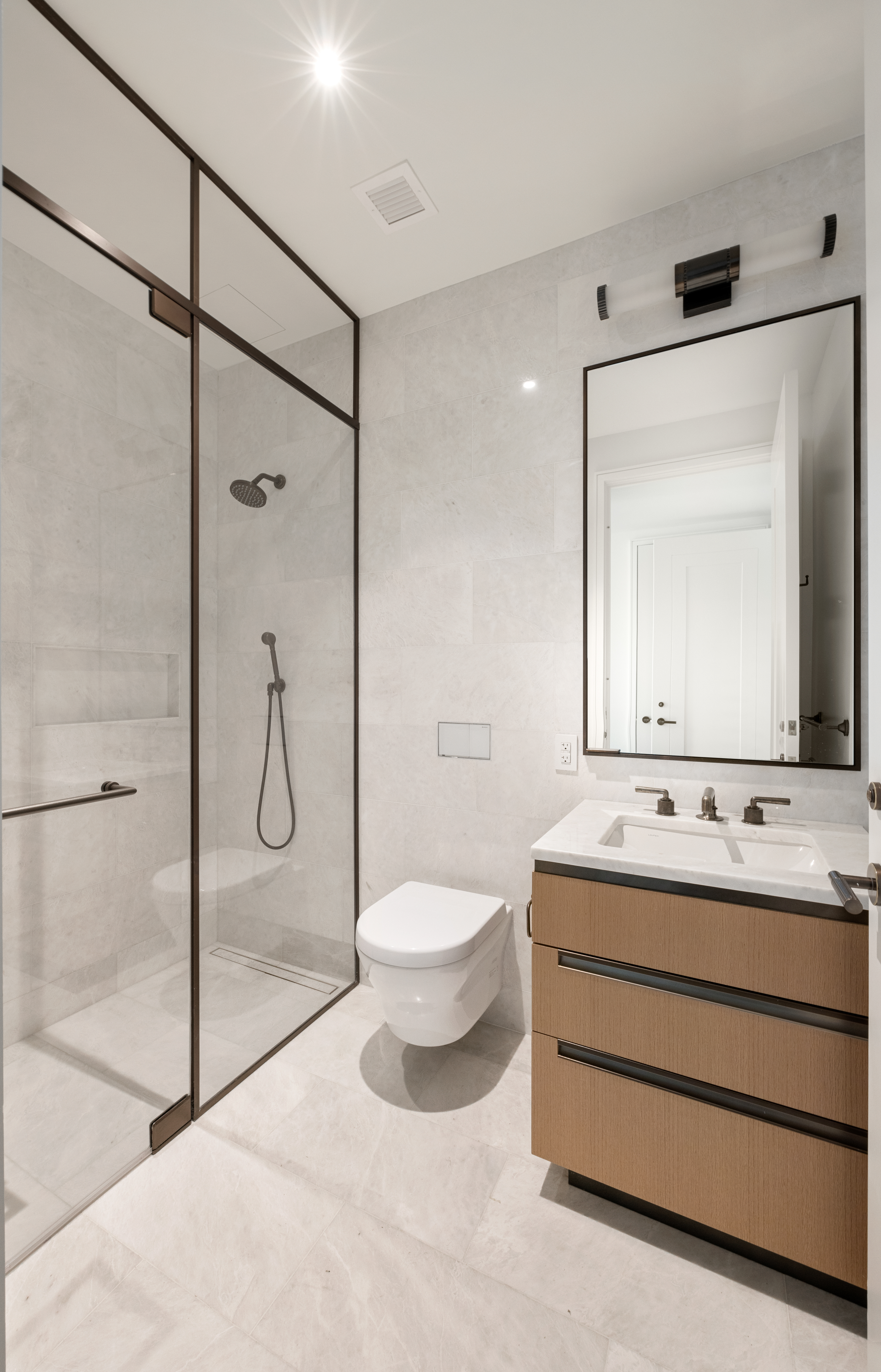 515 West 18th Street, Unit 1010 Manhattan, NY 10011 - Photo 5 of 19 a bathroom with a toilet sink shower and mirror