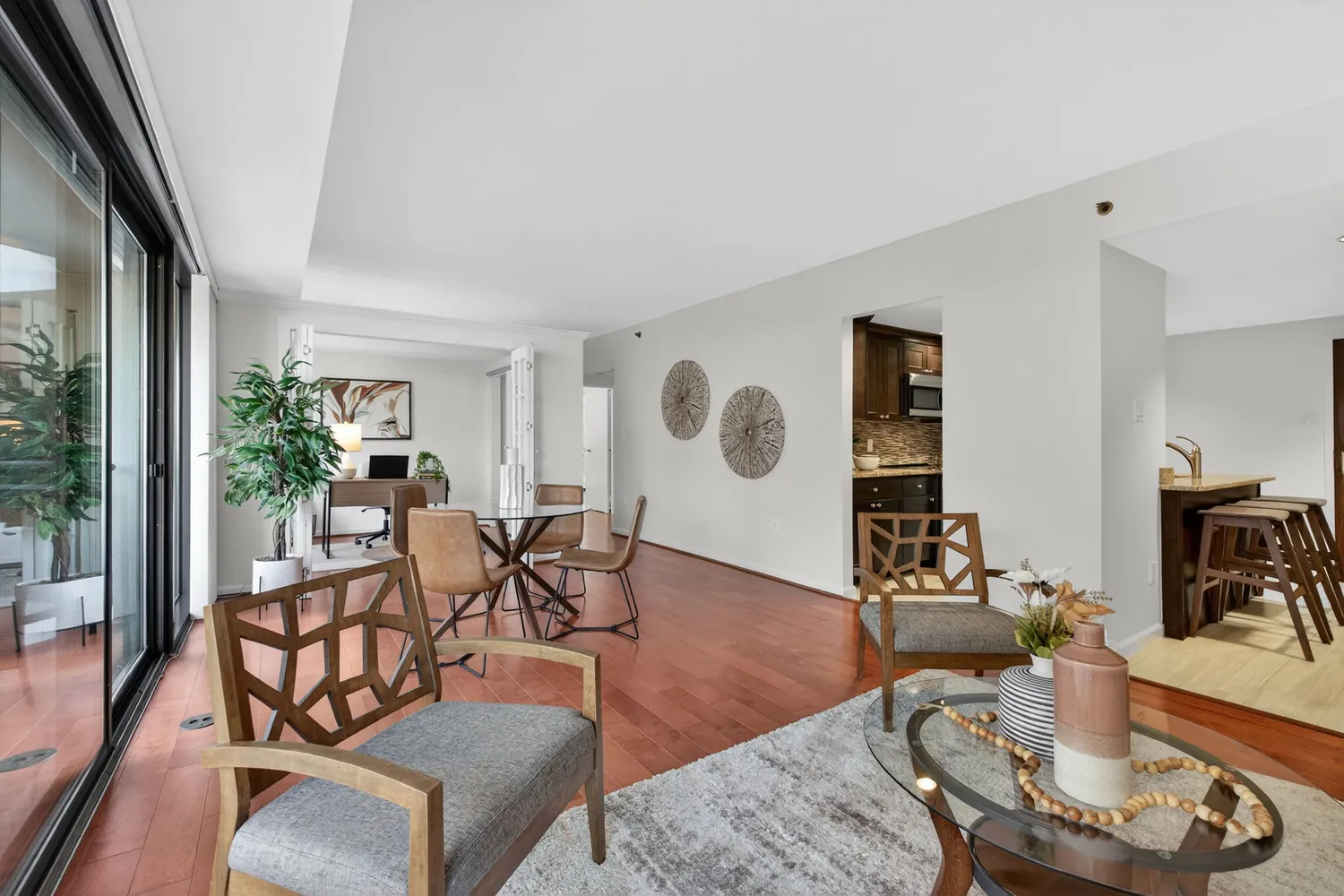 a living room with furniture and wooden floor