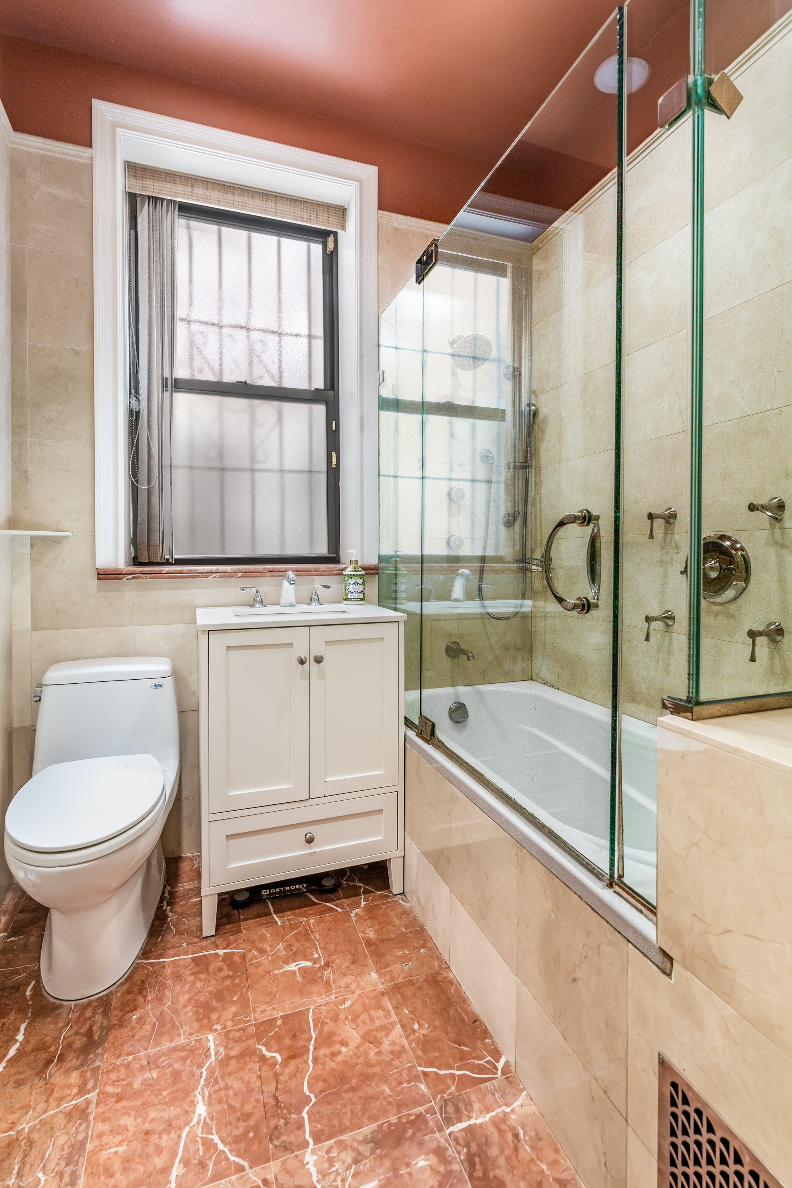 311 West 97th Street, Unit 1W Manhattan, NY 10025 - Photo 8 of 15 a bathroom with a granite countertop toilet a sink and bathtub