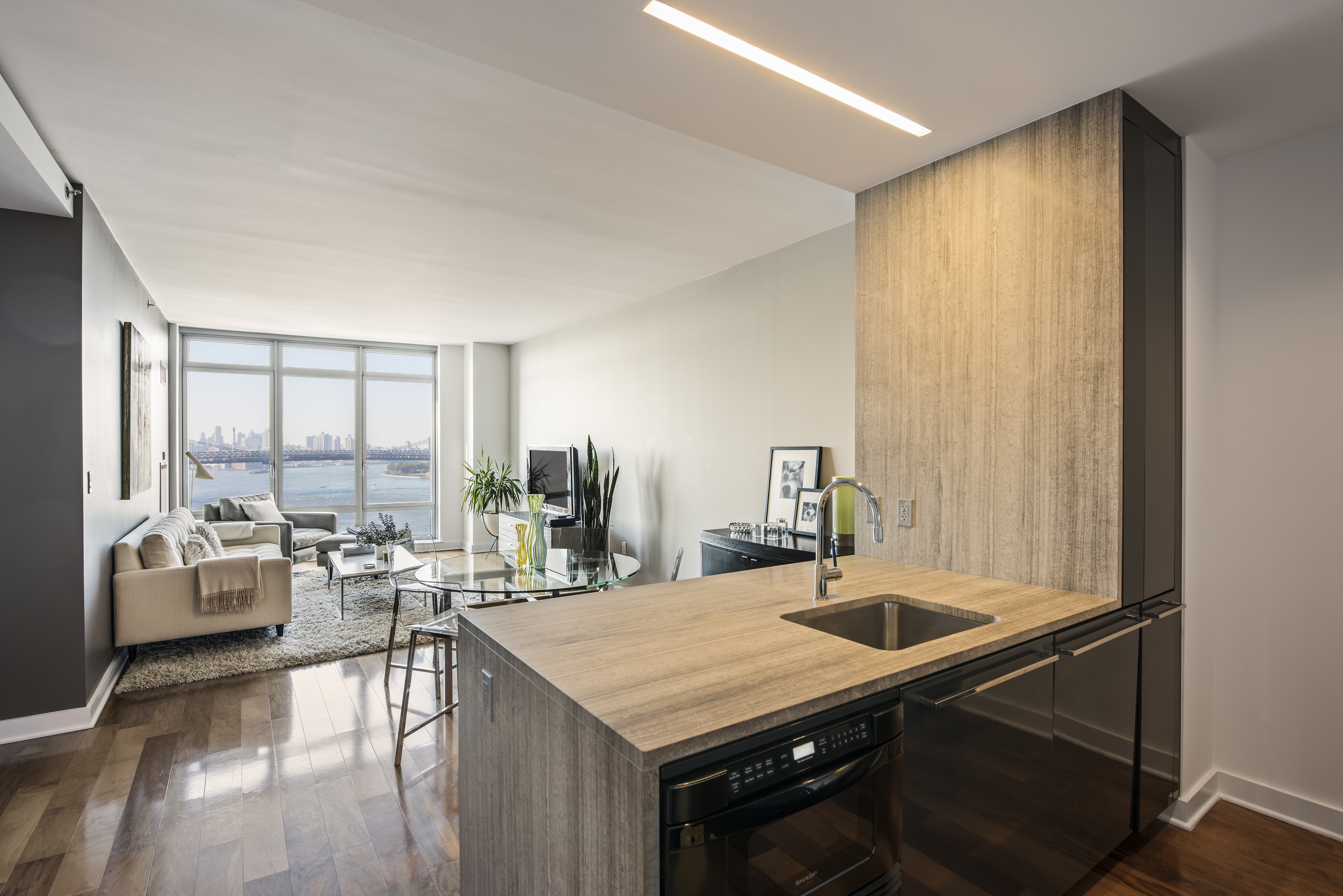 2 Northside Piers, Unit 20C Brooklyn, NY 11249 - Photo 3 of 12 a kitchen with a table chairs and window