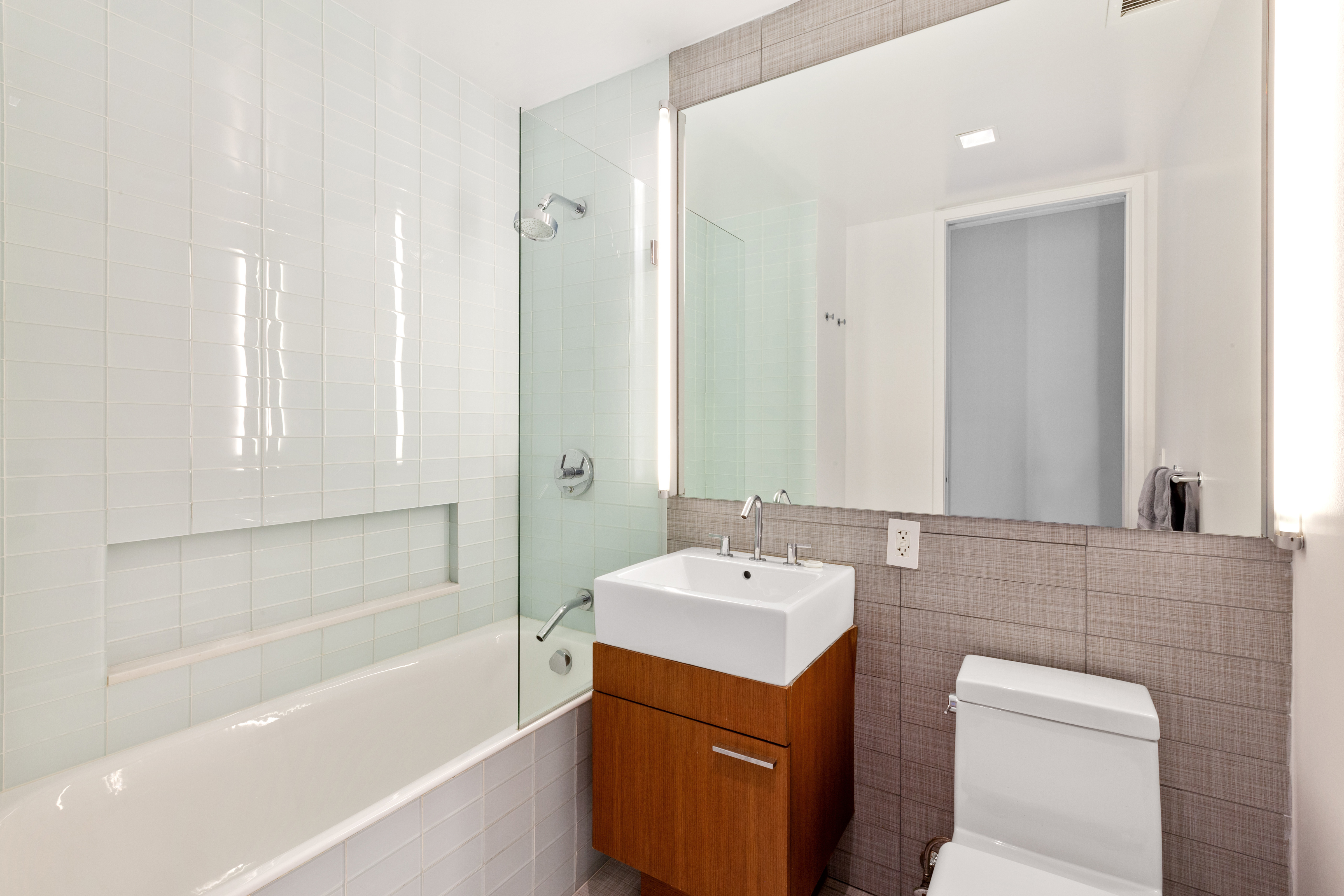 447 West 18th Street, Unit 7A Manhattan, NY 10011 - Photo 11 of 16 a bathroom with a tub sink and mirror