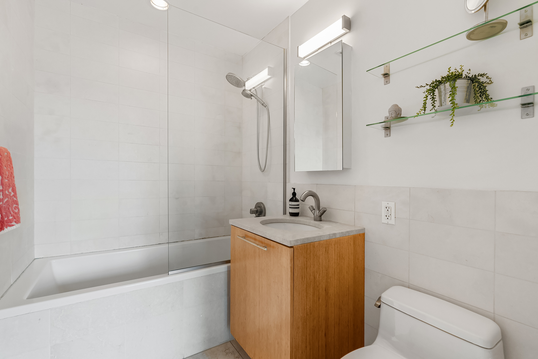1 Powers Street, Unit 404 Brooklyn, NY 11211 - Photo 7 of 14 a bathroom with a sink a toilet and shower