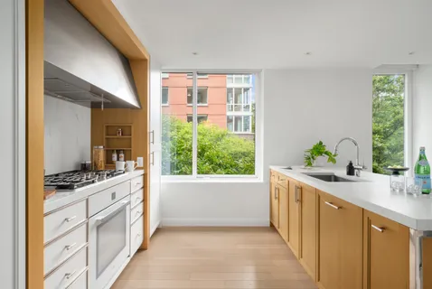 a kitchen with stainless steel appliances a sink a stove and a window