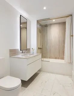 a bathroom with a sink mirror vanity and toilet