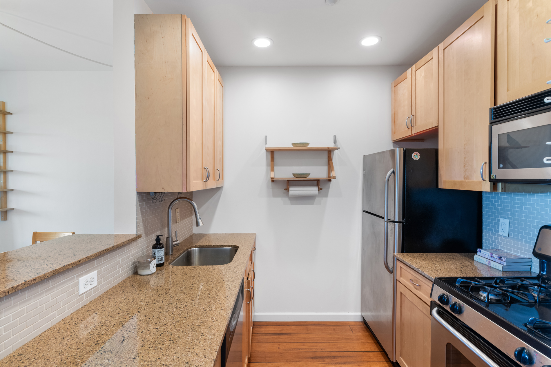 504 West 136th Street, Unit 6A Manhattan, NY 10031 - Photo 4 of 10 a kitchen with stainless steel appliances granite countertop a sink stove and refrigerator