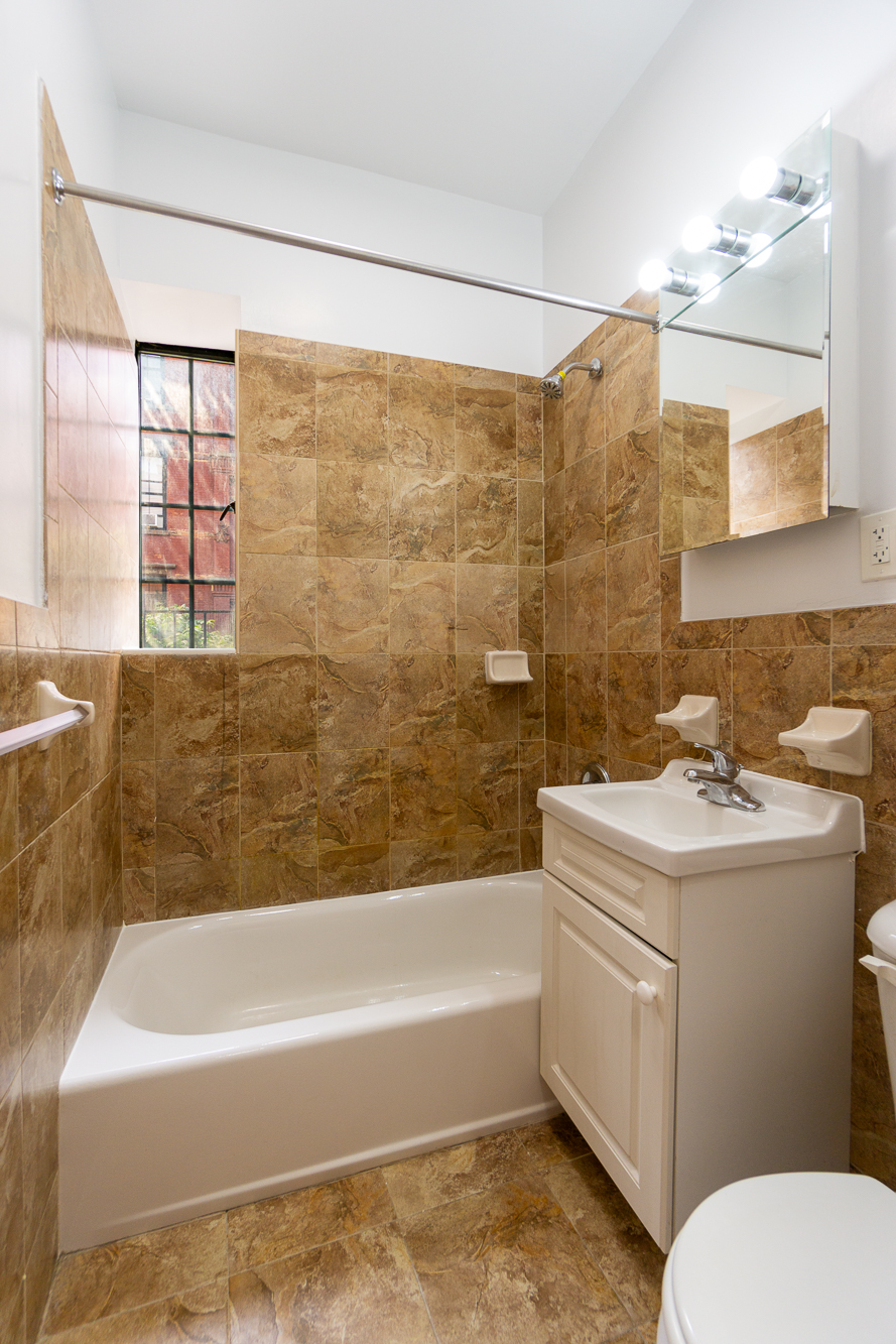 189 West 10th Street, Unit 2E Manhattan, NY 10014 - Photo 4 of 5 a bathroom with a sink toilet and shower