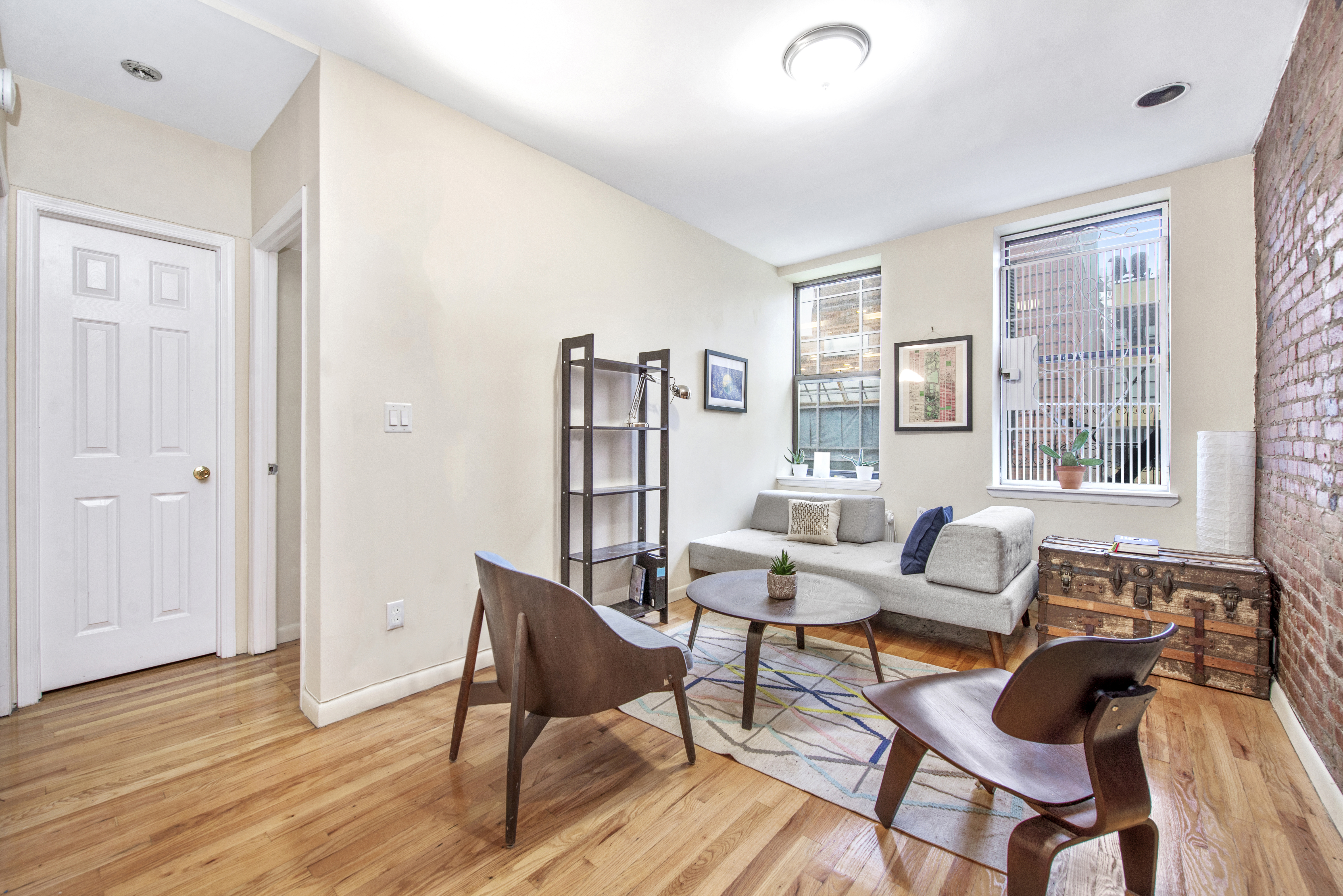 309 East 95th Street, Unit 23 Manhattan, NY 10128 - Photo 2 of 6 a living room with furniture and a wooden floor
