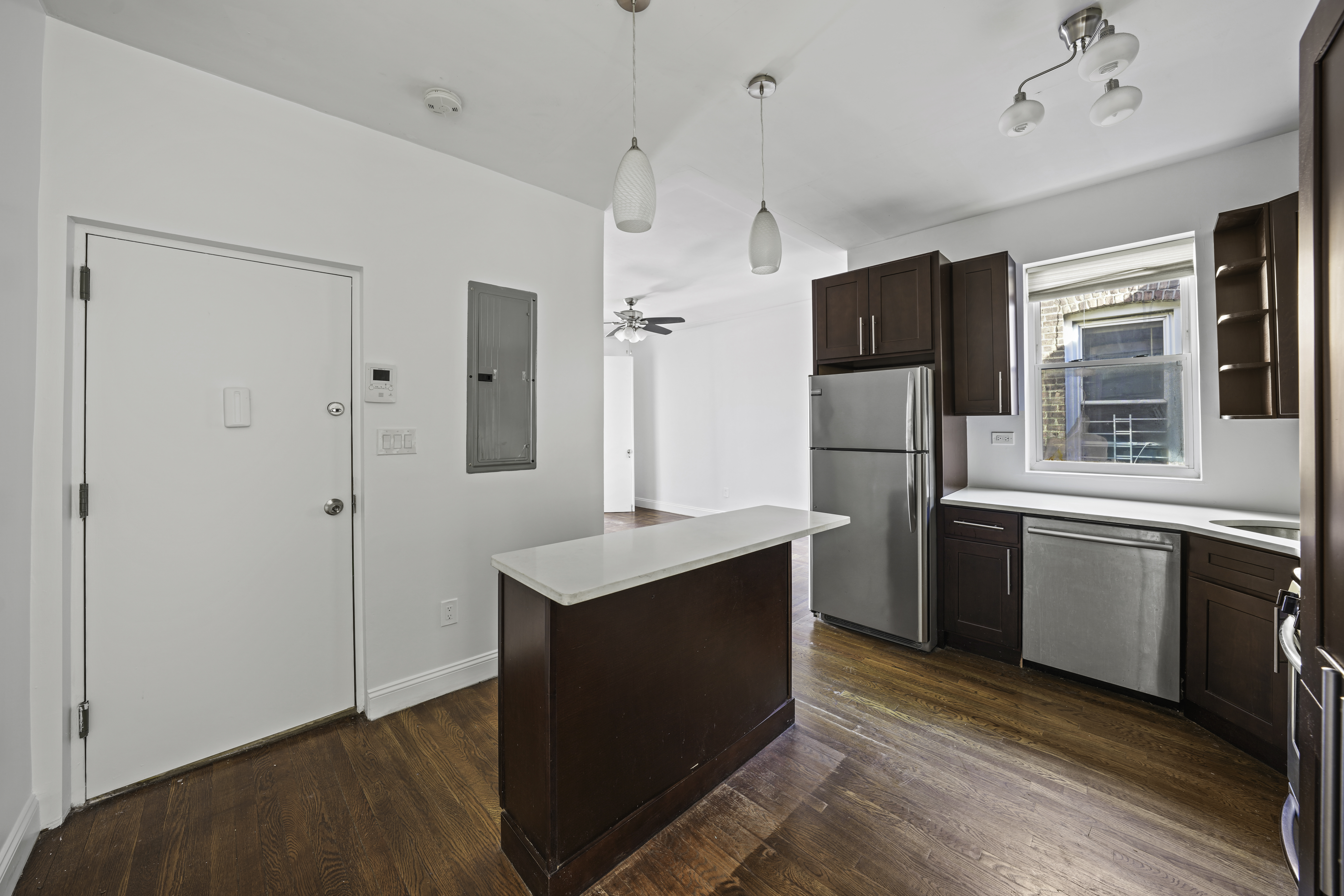 514 86th Street, Unit 4 Brooklyn, NY 11209 - Photo 3 of 19 a kitchen with refrigerator cabinets and wooden floor