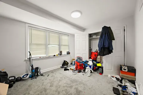 a view of a room with gym equipment and a window
