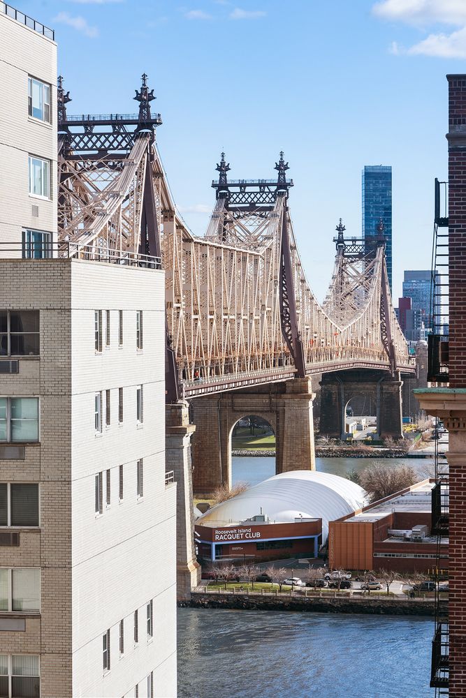 30 Sutton Place, Unit 14B Manhattan, NY 10022 - Photo 9 of 10 a front view of a building with garden