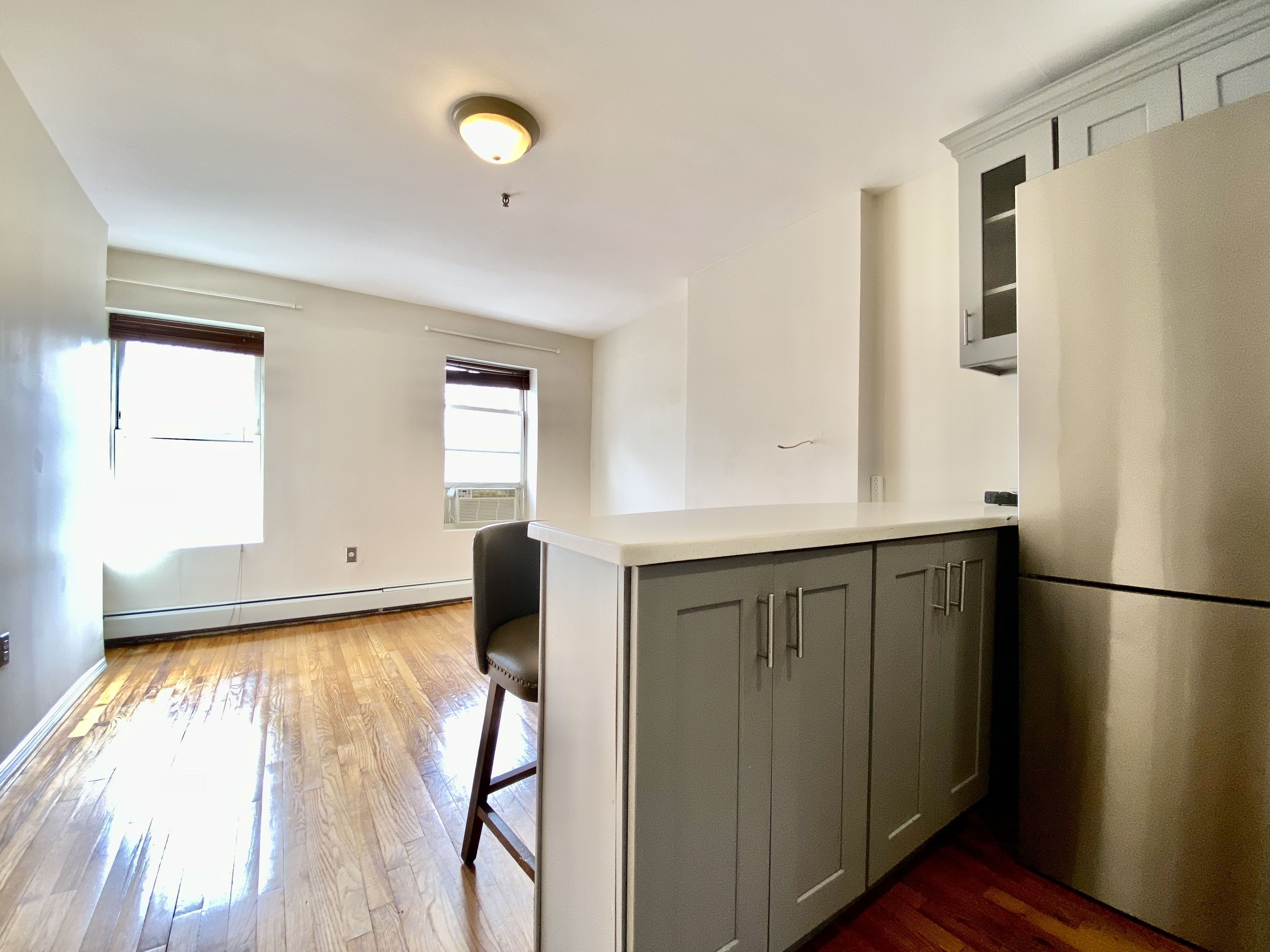 373 Gates Avenue, Unit 4 Brooklyn, NY 11216 - Photo 3 of 10 a view of a kitchen with wooden floor and cabinet