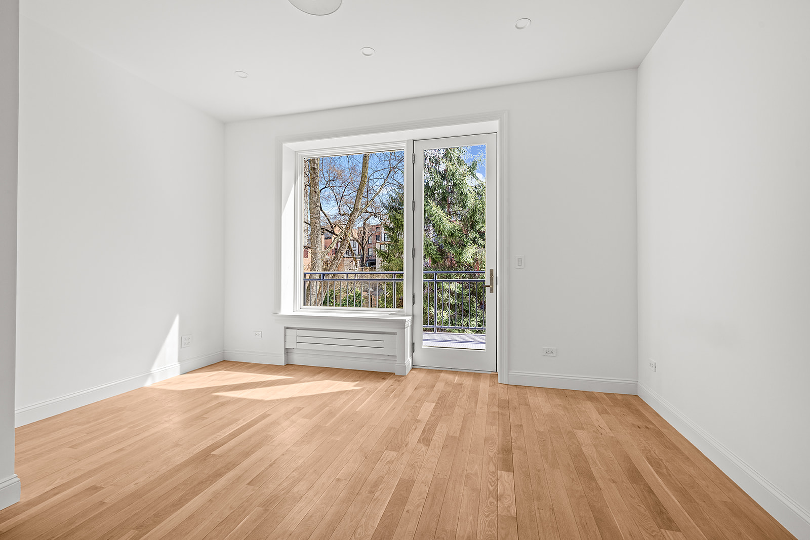 119 Henry Street, Unit 3 Brooklyn, NY 11201 - Photo 8 of 14 an empty room with wooden floor and windows
