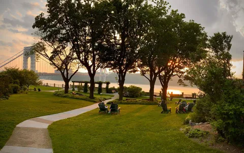 a view of yard with swimming pool and trees