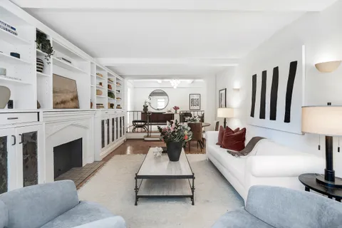 a living room with furniture fireplace and flat screen tv