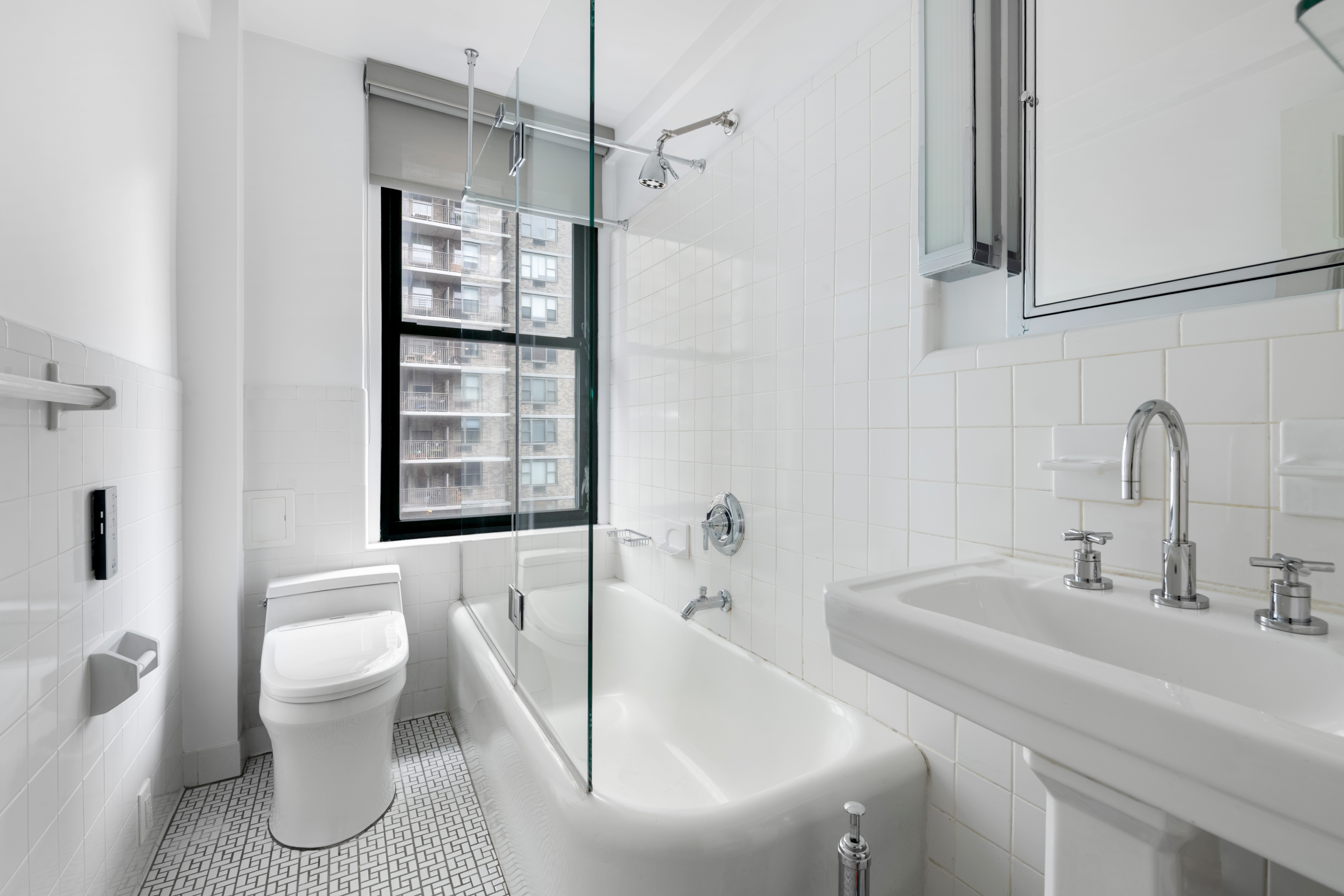 308 East 79th Street, Unit 13EF Manhattan, NY 10075 - Photo 11 of 16 a bathroom with a sink toilet and shower