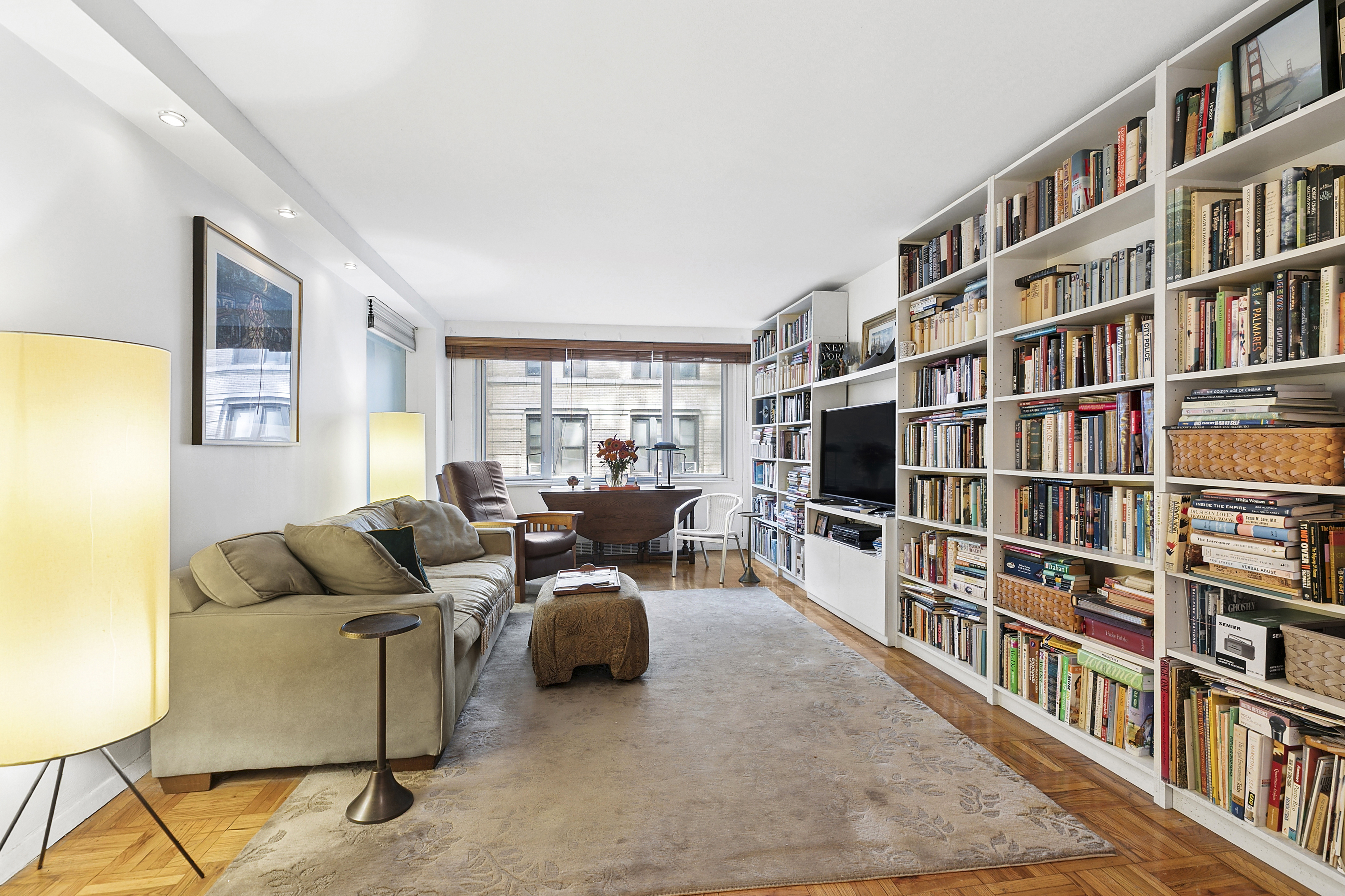 301 East 22nd Street, Unit 3PR Manhattan, NY 10010 - Photo 1 of 11 a living room with furniture and a book shelf