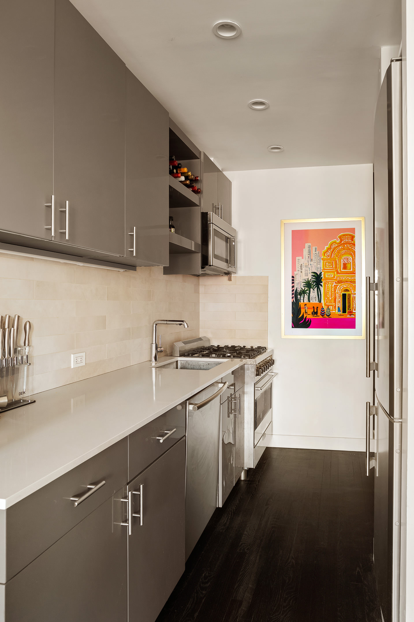 250 West 15th Street, Unit PH6E Manhattan, NY 10011 - Photo 6 of 9 a kitchen with stainless steel appliances a sink a stove and a refrigerator