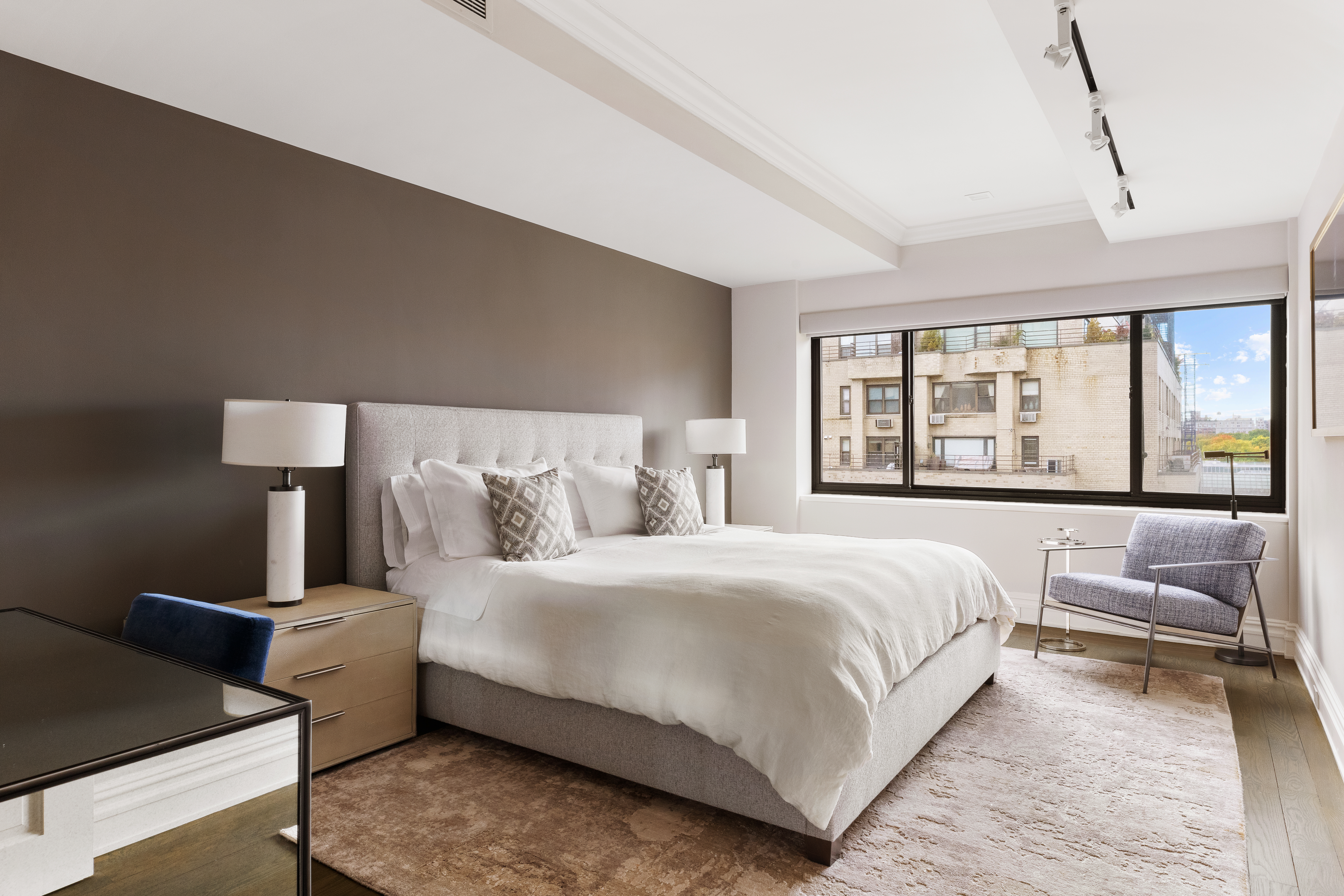 25 East 83rd Street, Unit 10D Manhattan, NY 10028 - Photo 9 of 17 a bedroom with a bed and a large window