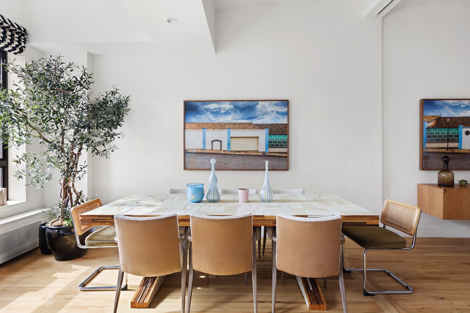 a dining room with furniture a rug and wooden floor
