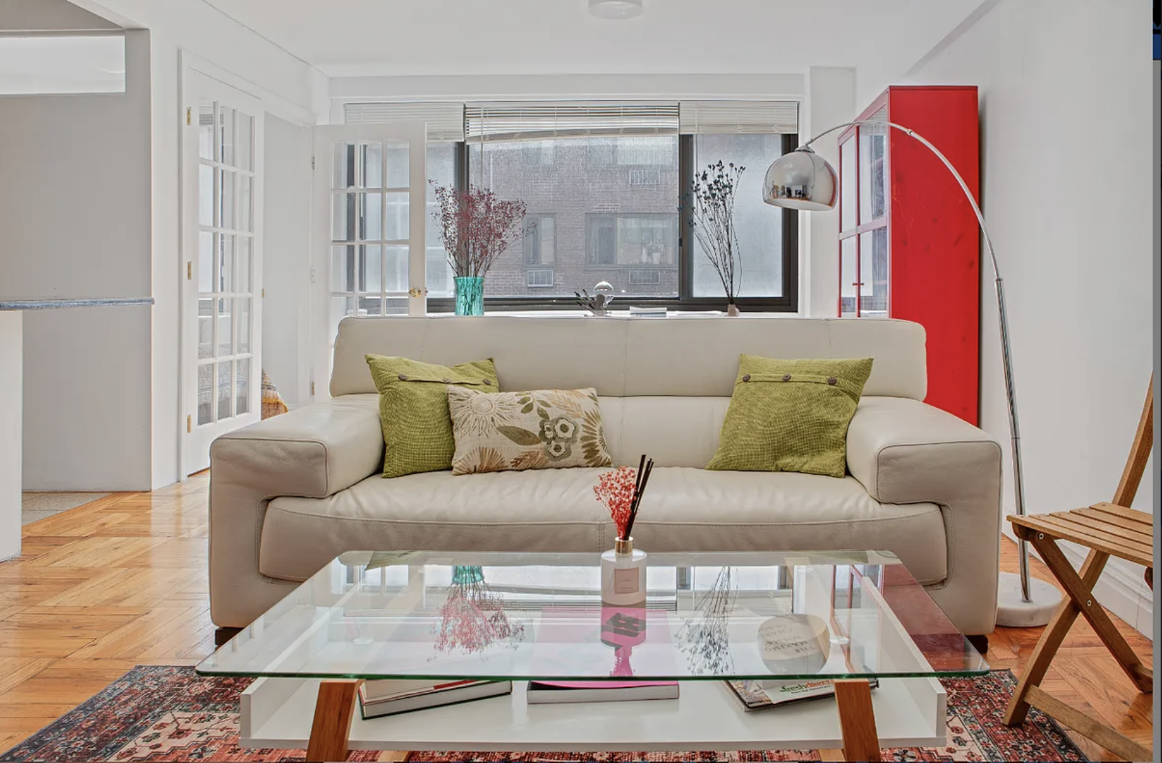 420 East 64th Street, Unit E7K Manhattan, NY 10065 - Photo 2 of 10 a living room with furniture and wooden floor