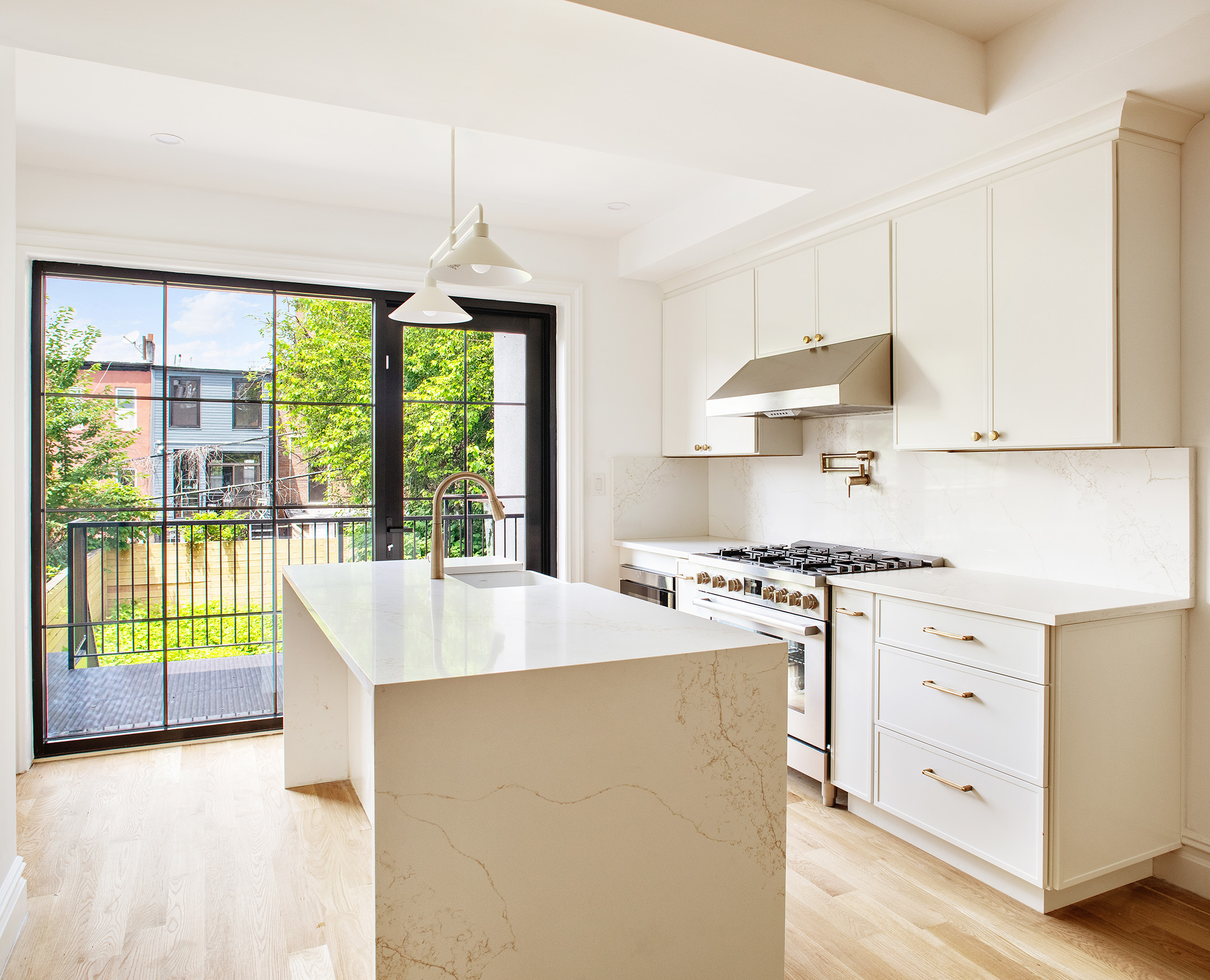 99 Somers Street Brooklyn, NY 11233 - Photo 4 of 14 a kitchen with a stove a sink and a refrigerator