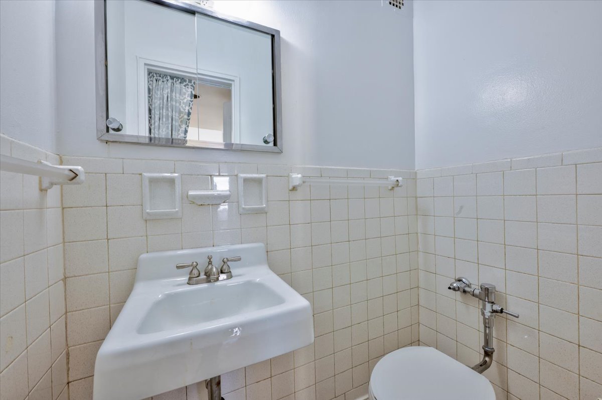 1270 East 51st Street, Unit 6X Brooklyn, NY 11234 - Photo 14 of 17 a bathroom with a toilet sink and mirror