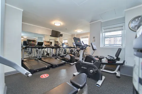 a room with gym equipment and windows