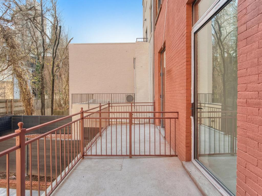 231 East 60th Street, Unit 2 New York, NY 10022 - Photo 7 of 9 a view of a balcony with wooden fence and floor