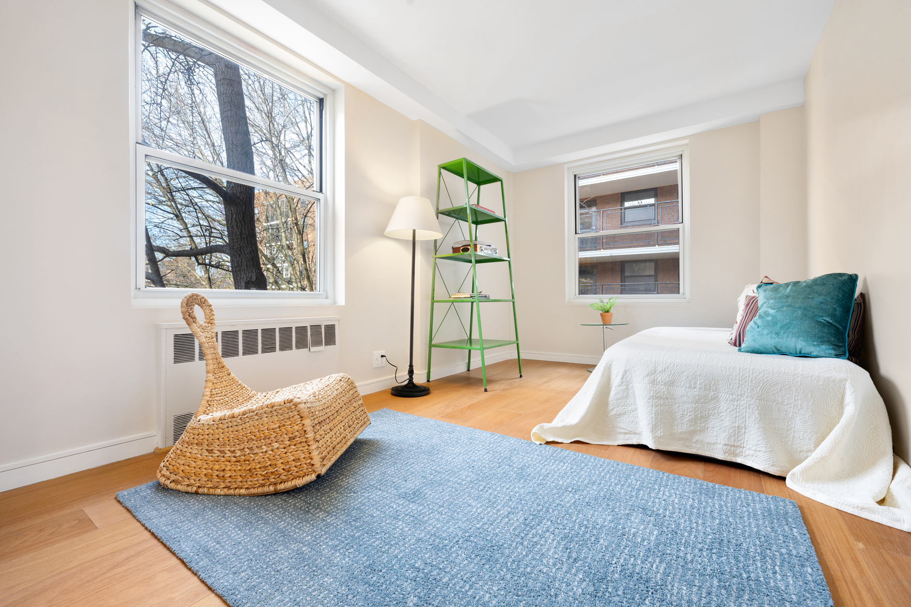 35-51 85th Street, Unit 5E Queens, NY 11372 - Photo 13 of 16 a bedroom with a bed and a window