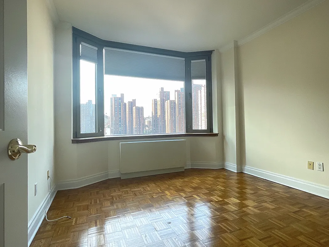 400 East 90th Street, Unit 15B Manhattan, NY 10128 - Photo 5 of 15 a view of an empty room and window