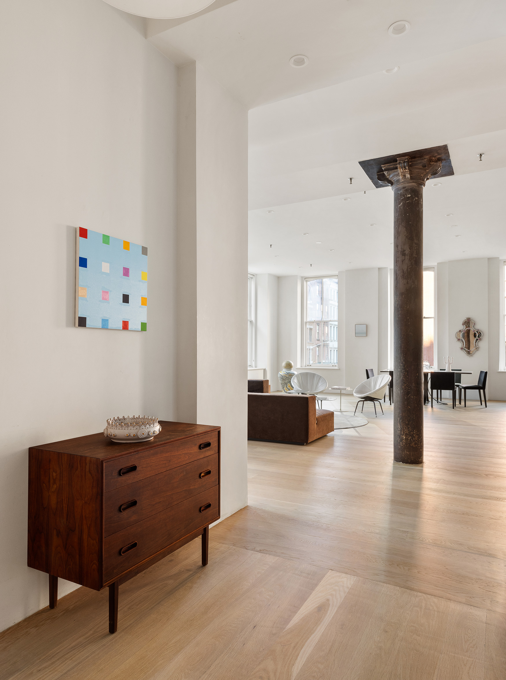 60 Warren Street, Unit 2 Manhattan, NY 10007 - Photo 15 of 16 a living room with furniture and a dining table with wooden floor