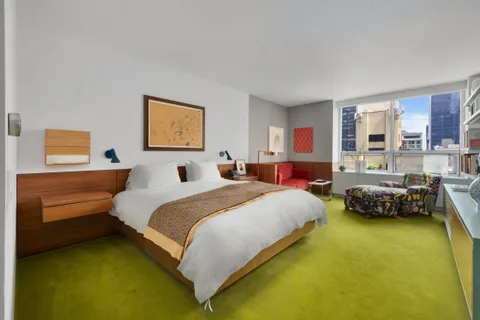 a bedroom with a bed and a couch