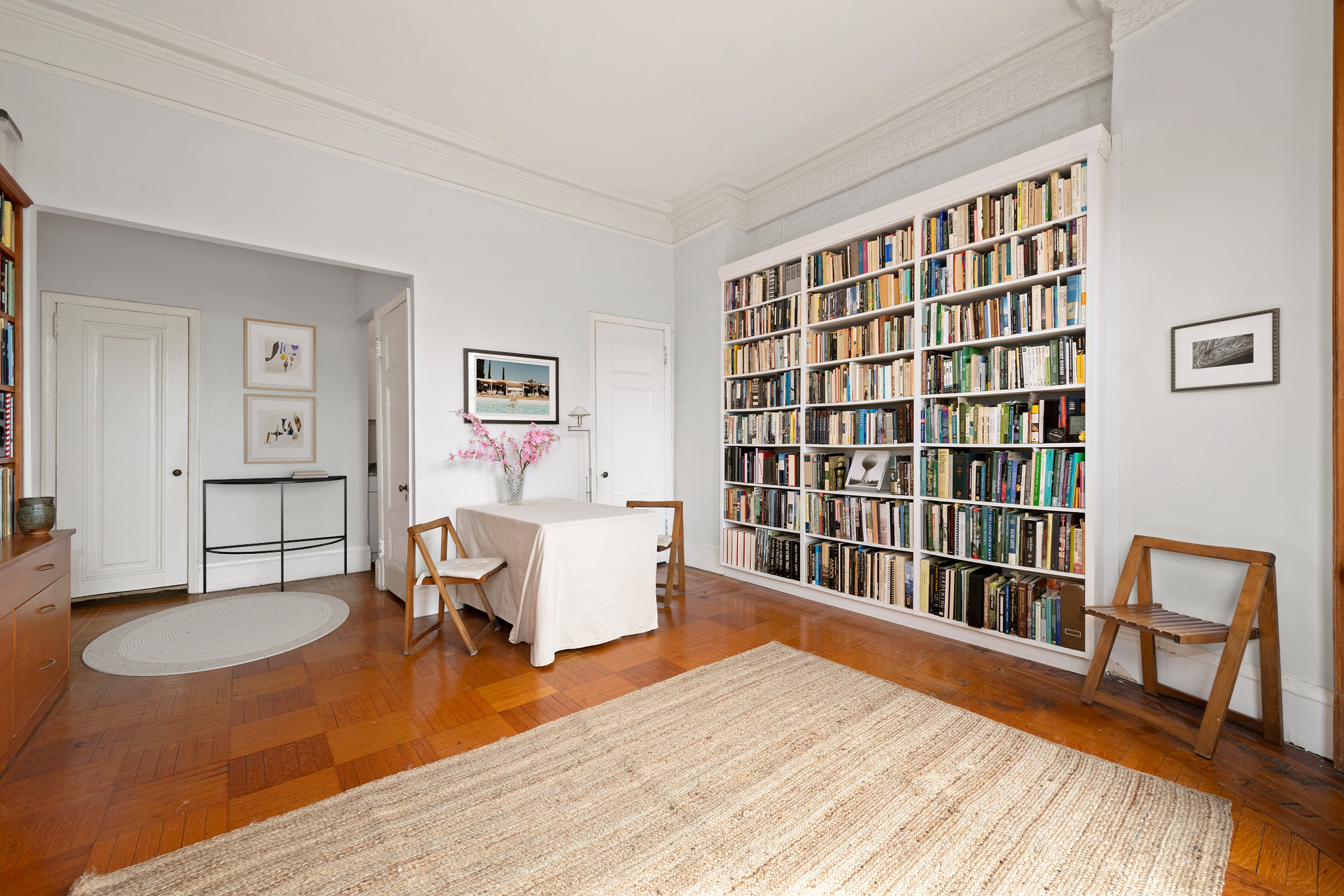 293 Riverside Drive, Unit 2A Manhattan, NY 10025 - Photo 3 of 6 a living room with furniture and a book shelf