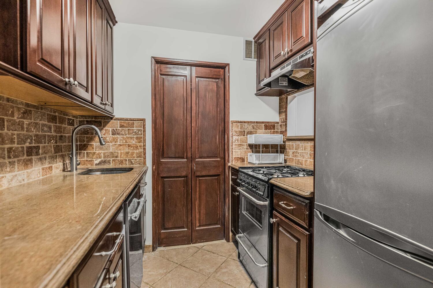 4 West 109th Street, Unit 4F Manhattan, NY 10025 - Photo 5 of 16 a kitchen with stainless steel appliances granite countertop a refrigerator and a sink