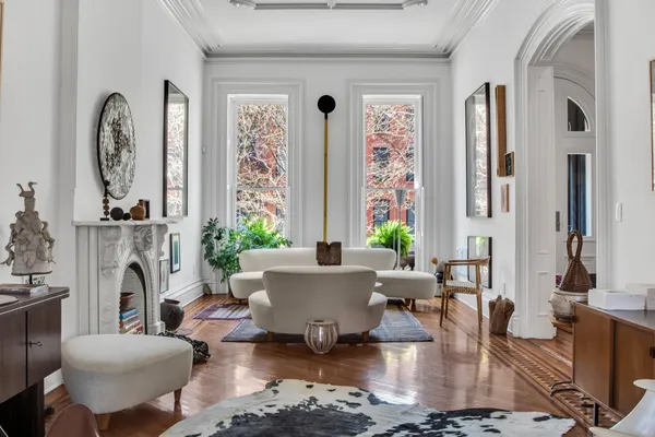 a living room with fireplace furniture and a large window