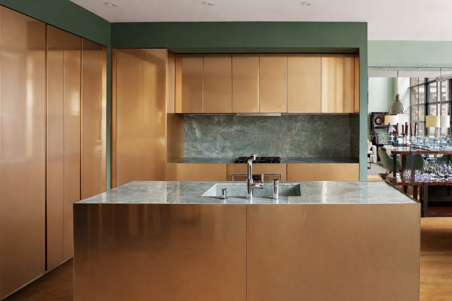 456 West 19th Street, Unit 6/7F Manhattan, NY 10011 - Photo 4 of 13 a view of a kitchen with kitchen island a sink wooden floor and a window