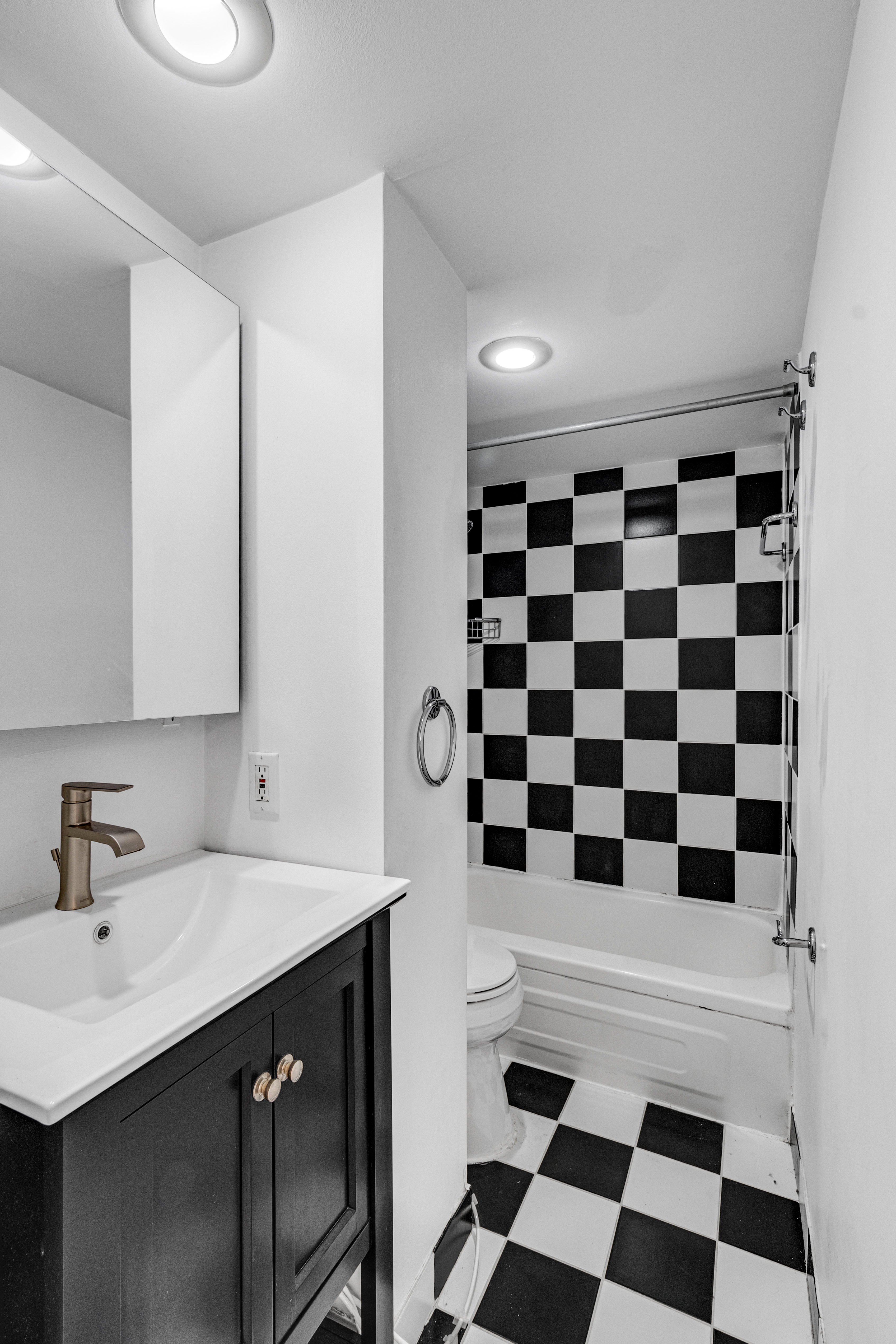 207 East 21st Street, Unit 6B Manhattan, NY 10010 - Photo 8 of 11 a bathroom with a sink a toilet a shower and a mirror