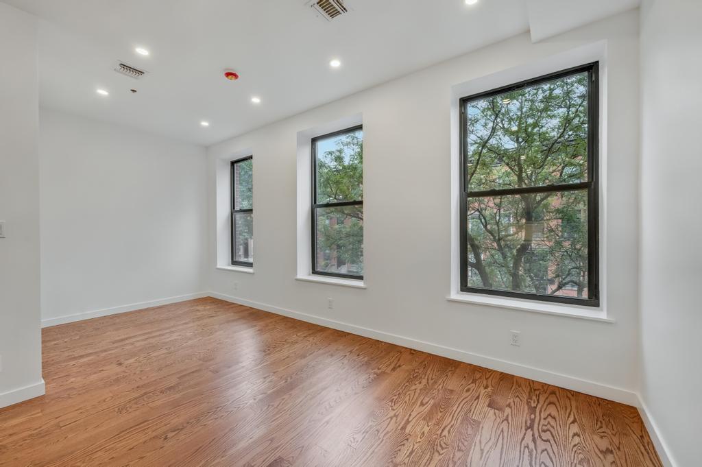 109 President Street, Unit 4 Brooklyn, NY 11231 - Photo 8 of 22 a view of an empty room with wooden floor and a window