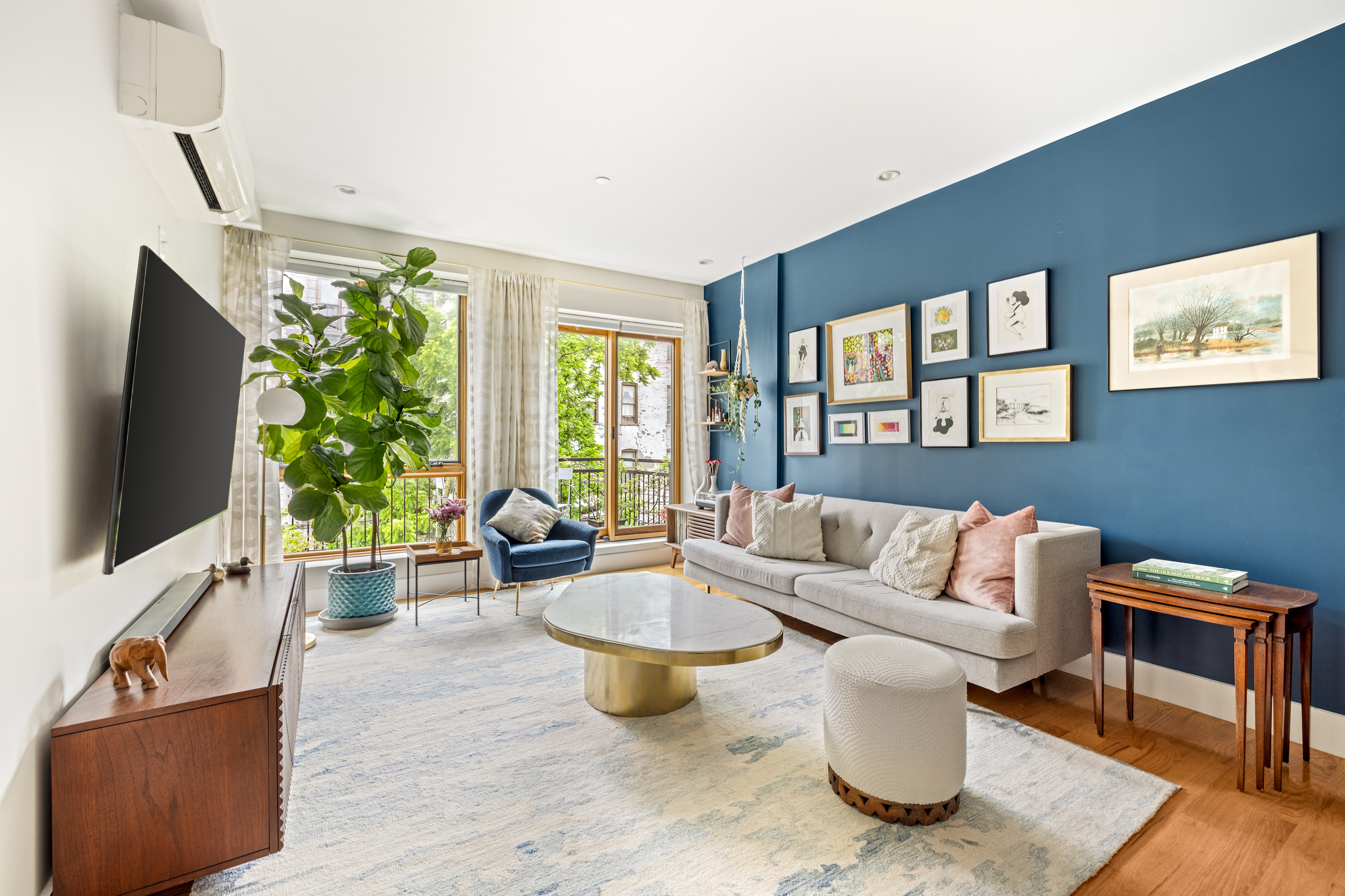 a living room with furniture and a flat screen tv