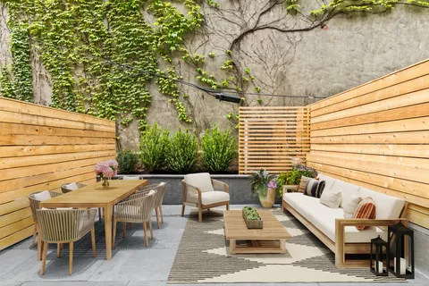 a backyard of a house with outdoor seating