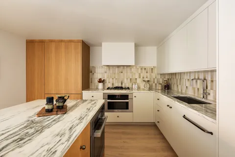 a kitchen with stainless steel appliances granite countertop a stove and more cabinets
