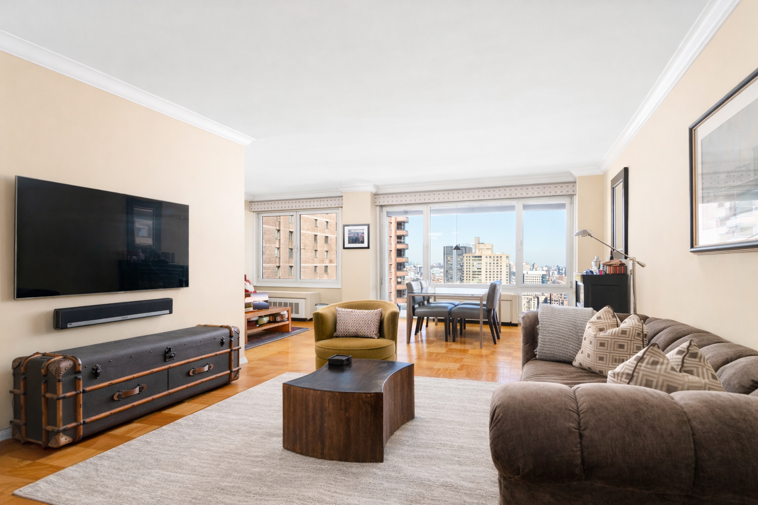 50 East 89th Street, Unit 31C Manhattan, NY 10128 - Photo 3 of 18 a living room with furniture and a flat screen tv