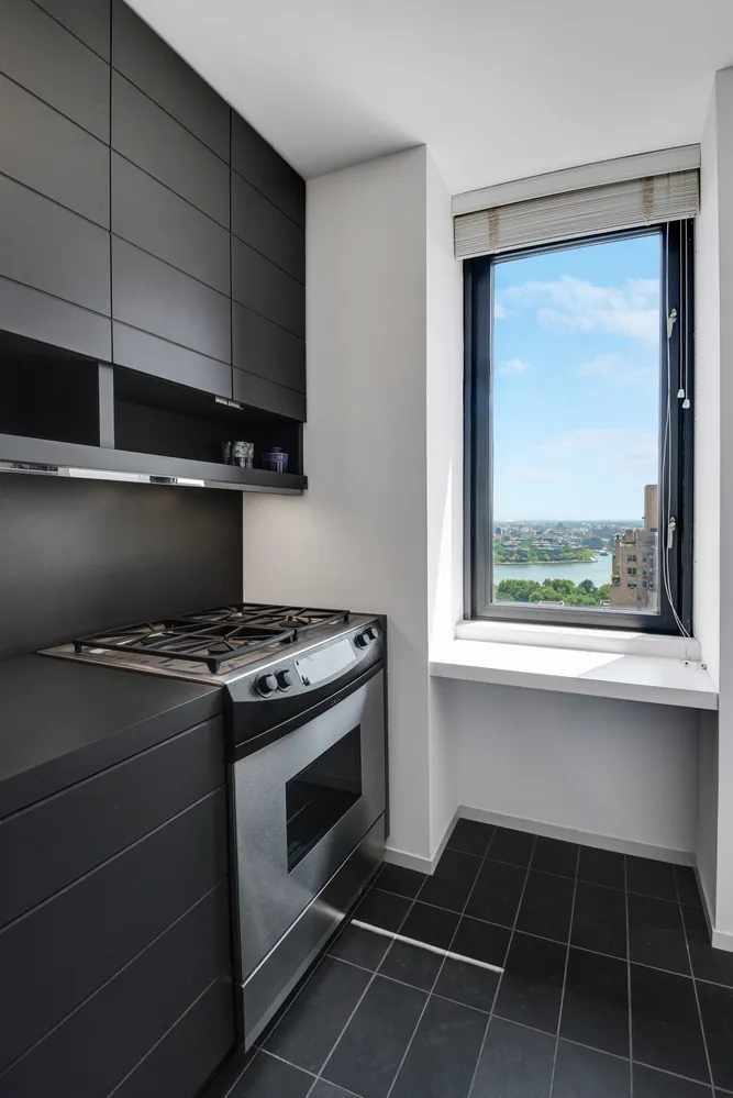 a stove top oven sitting inside of a kitchen